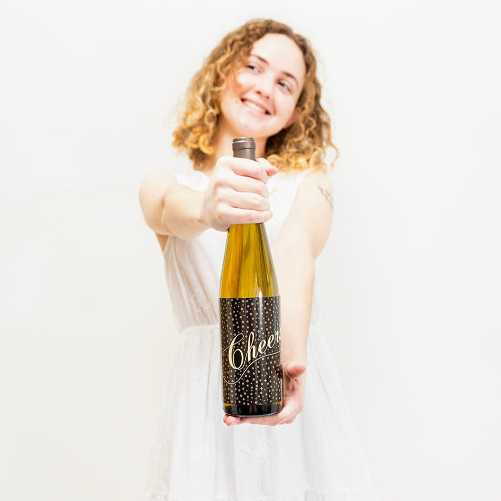 Woman holding a bottle labeled 'Cheer' against a white background